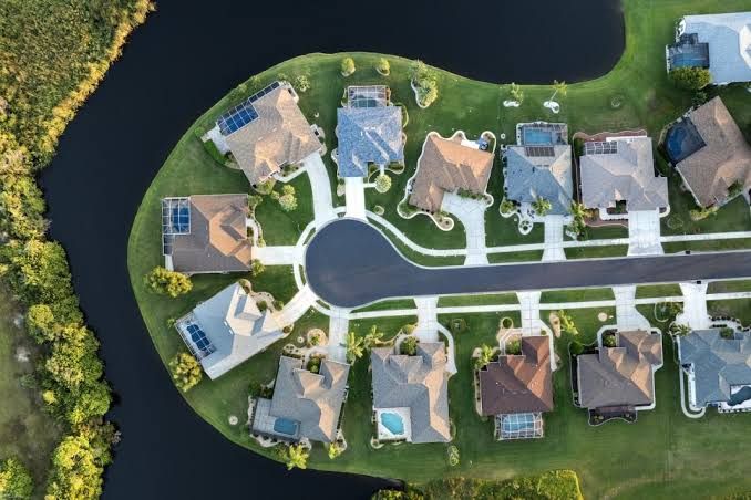 Overhead aerial of a suburban cul-de-sac with rooftop solar.